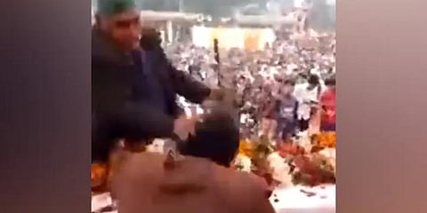 The elderly farmer was identified as Chhatrpal and the video footage showed policemen taking him away after he hit BJP MLA Pankaj Gupta on the dais. (Photo | Twitter)