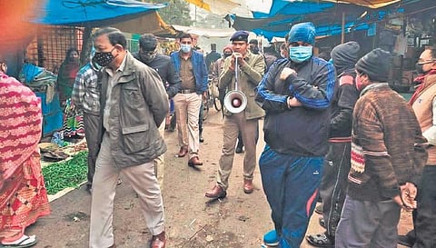 Police enforcing Covid norms at a marketplace in Rourkela on Friday. (Photo | Express)