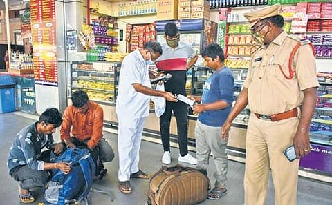 An RTC official imposes fine on passengers who were seen without face masks at PNBS in Vijayawada on Saturday | Prasant Madugula