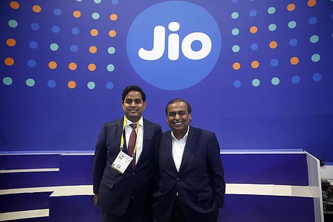 Reliance Industries Ltd Chairman Mukesh Ambani with his son Akash Ambani poses for photographs at Reliance Jios stall during the 6th India Mobile Congress at Pragati Maidan in New Delhi. (Photo | Shek