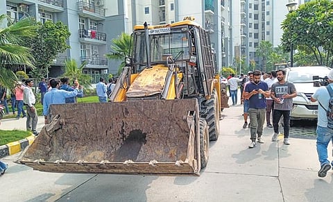 Noida Authority workers during the demolition drive on Friday: PTI