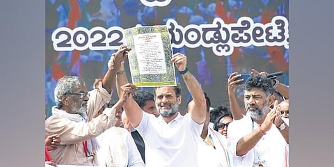 Congress MP Rahul Gandhi shows the Preamble which was handed over by noted writer Devanuru Mahadeva in Mysuru on Friday | Uday Shankar s