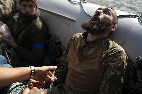 A Ukrainian soldier reacts as he receives an injection during an evacuation of injured soldiers participating in the counteroffensive, near the retaken village of Shchurove, Ukraine. (Photo | AP)