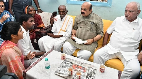 Karnataka Chief Minister Basavaraj Bommai and BJP strongman B S Yediyurappa at the residence of a Dalit man. (Photo | Basavaraj S Bommai Twitter)
