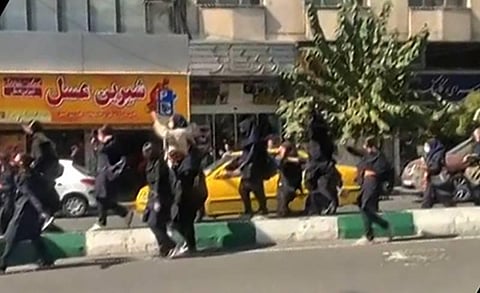 This grab taken from a UGC video made available on the ESN platform on October 12, 2022 shows Iranian students, some without headscarves, shouting 'Death to the dictator' as they march. (Photo | AFP)