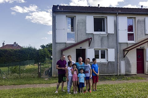Olga Lopatkina and her children pose for a photo in front of their house in Loue, western France. (Photo | AP)