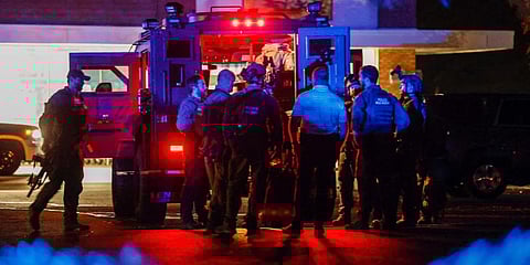 Law enforcement officers congregate outside an armored vehicle at the Aldi on New Bern Avenue in Raleigh after five people were shot and killed in Raleigh, N.C. (Photo | AP)