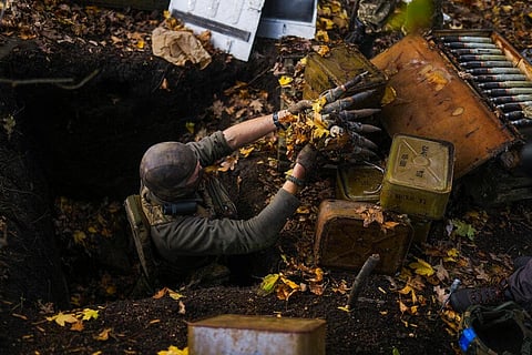 A Ukrainian territorial defence deminer takes Russian ammunition left behind as his team clears mines near Hrakove village, Ukraine. (Photo | AP)