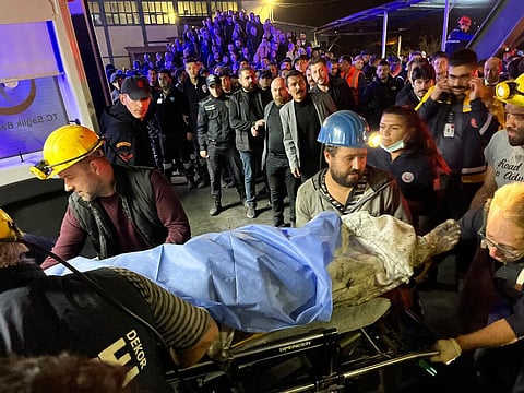 Miners carry the body of a victim in Amasra, in the Black Sea coastal province of Bartin, Turkey. (Photo | AP)