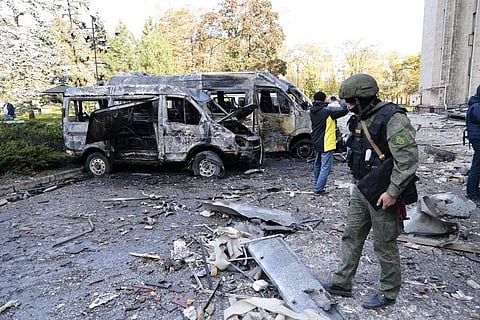 Investigators inspect a site after shelling near an administrative building, in Donetsk, the capital of Donetsk People's Republic, eastern in Ukraine. (Photo | AP)