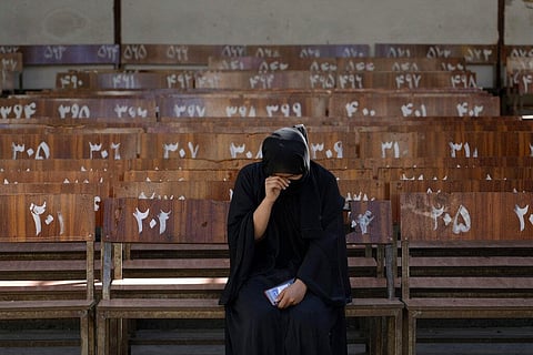 A 19-year old Hazara Afghan girl sits and cries on the bench she was sitting on, during Friday's suicide bomber attack on a Hazara education center, in Kabul, Afghanistan on Oct 1, 2022 (Photo | AP)