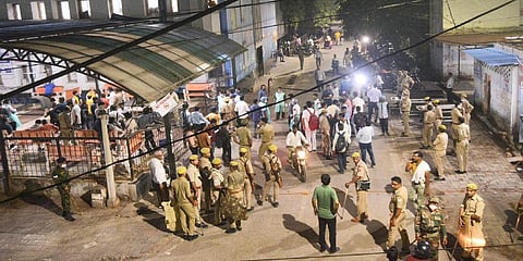 Police personnel and others gather as injured people are brought for treatment following an accident at Ghatampur area in Kanpur district, Saturday night, Oct. 1, 2022.(PTI)