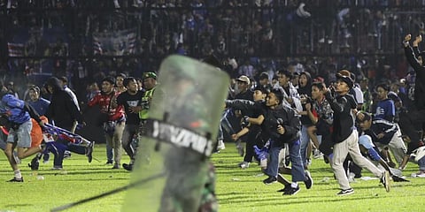 Soccer fans enter the pitch during a clash between supporters at Kanjuruhan Stadium in Malang,IndonesiaPanic following police actions left over 100 dead.(Photo | AP)
