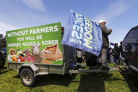 New Zealand farmers protest in central Auckland on government plans to make them pay for greenhouse gas emissions. (Photo | AP)