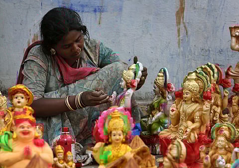 An artist gives final touches to idols of Hindu Goddess Lakshmi, the Goddess of wealth, ahead of Diwali, the festival of lights in Hyderabad | AP