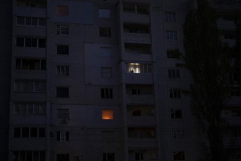 A man looks out from a window in a building damaged by fighting between Ukrainian and Russian forces in Borodyanka, Kyiv region, Oct 21, 2022. (Photo | AP)