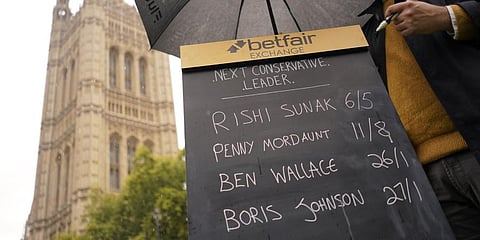 A bookmaker takes bets for the next British Prime Minister after Liz Truss resigned in London. (Photo | AP)