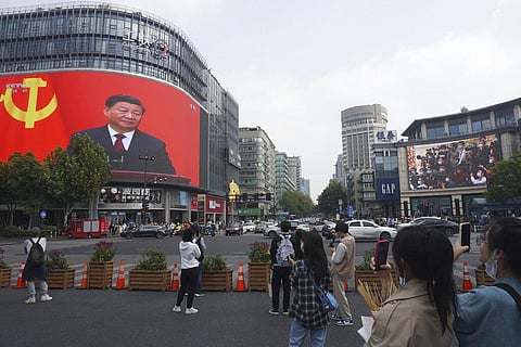 Chinese President Xi Jinping is seen at the end of the Chinese Communist Party's 20th Party Congress on a giant screen a commercial district of Hangzhou | AP