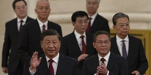 New members of the Politburo Standing Committee, front to back, President Xi Jinping, Li Qiang, Zhao Leji, Wang Huning, Cai Qi, Ding Xuexiang, and Li Xi arrive at the Great Hall. (Photo | AP)