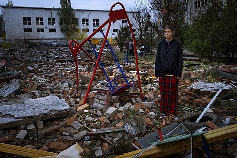 Taisiia Kovaliova, 15, stands amongst the rubble of a playground in front of her house hit by a Russian missile in Mykolaiv, Sunday, Oct. 23, 2022. (Photo | AP)