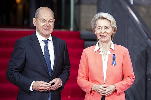 German Chancellor Olaf Scholz and European Commission President Ursula von der Leyen stand at the entrance of the Westhafen Event and Convention Center in Berlin. (Photo | AP)