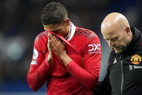 Manchester United's Raphael Varane,(L), leaves the field after he was injured during the match between Manchester United and Chelsea in London, Oct. 22, 2022. (Photo|AP)