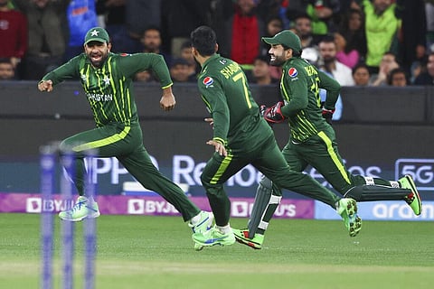 Pakistan's Iftikhar Ahmed, left, celebrates with teammates after taking a catch to dismiss India's Rohit Sharma during the T20 World Cup cricket match between India and Pakistan. (Photo | AP)