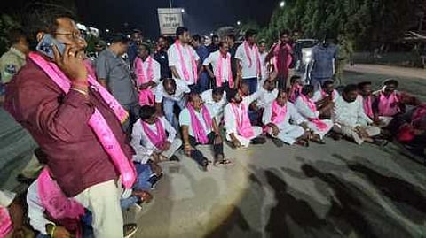 Ministers Gangula Kamalakar, V Srinivas Goud and A Indrakaran Reddy stage a dharna protesting against the BJP's plan to 'purchase' TRS MLAs, on the Vijayawada-Hyderabad Highway. (Photo | EPS)