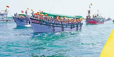 Fishing boats, with people singing Kannada songs, sail into the sea off the Malpe coast during the ‘Koti Kantha Gayana’ programme on Friday | Express