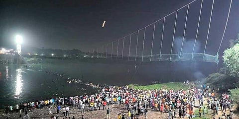 Rescue operation underway after an old suspension bridge over the Machchhu river collapsed, in Morbi district, Sunday, Oct. 30, 2022. (PTI)