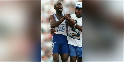 Jim Redmond helping his injured sprinter son Derek Redmond at the 1992 Barcelona Olympics. (Photo | AFP)