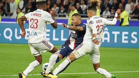 PSG's Kylian Mbappe, challenges the ball with Lyon's Thiago Mendes, and Lyon's Malo Gusto during the French League One soccer match between Lyon and Paris Saint Germain. (Photo | AP)