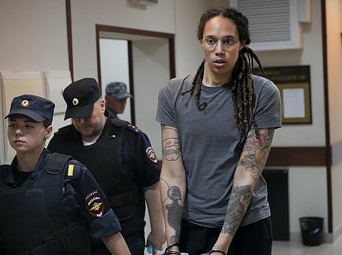 WNBA star and two-time Olympic gold medalist Brittney Griner is escorted from a courtroom after a hearing in Khimki just outside Moscow, Russia, on Aug. 4, 2022. (File Photo | AP)