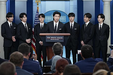 RM, center, accompanied by other K-pop supergroup BTS members from left, V, Jungkook, Jimin, Jin, J-Hope, and Suga speaks at the White House. (Photo | AP)