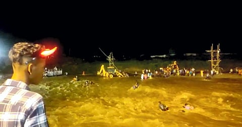 Jalpaiguri: Rescuers attempt to stop people from getting swept in flash floods in the Mal river, in Jalpaiguri district, West Bengal. (Photo | PTI)