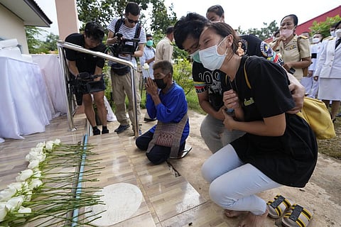 Relatives mourn during a ceremony for those killed in the attack on the Young Children's Development Center in north eastern Thailand. (Photo | AP)