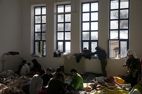 Migrants, most of them from Afghanistan, rest at an old school used as a temporary shelter on the island of Kythira, southern Greece, Friday, Oct. 7, 2022. (Photo | AP)