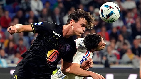 Lyon's Nicolas Tagliafico, right, challenges for the ball with Toulouse's Rasmus Nicolaisen during the French League One soccer match. (Photo | AP)