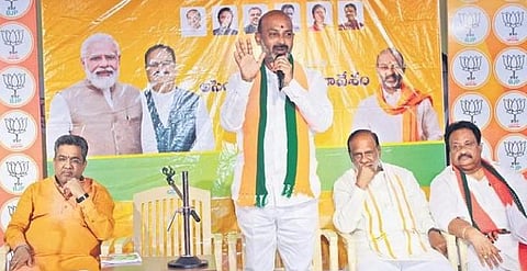 Bandi Sanjay addresses a party meeting in Hyderabad on Saturday as Telangana BJP in-charge Sunil Bansal and MP Laxman look on