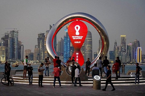 People gather around the official countdown clock showing remaining time until the kick-off of the World Cup 2022, in Doha, Qatar. (Photo | AP)