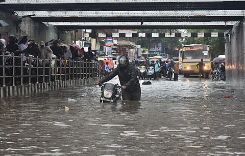 Local residents struggle to cross the flooded Ganeshapuram Subway in Vyasarapadi, following incessant rains, on November 1, 2022. (Photo | P Jawahar, EPS)