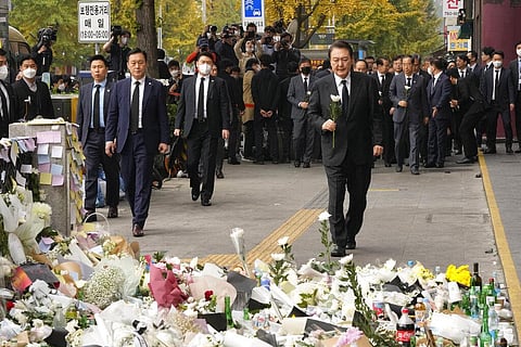 South Korean President Yoon Suk Yeol, right, arrives to pay tribute to victims of a deadly accident following Saturday night's Halloween festivities on a street near the scene in Seoul, S. Korea (AP)