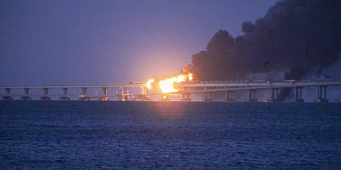 Flame and smoke rise from the massive explosion on the Kerch Strait Bridge that links Crimea to Russia, in Kerch, Crimea, Oct. 8, 2022. (Photo | AP)