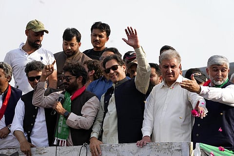 Pakistan's former Prime Minister Imran Khan, center, waves to his supporters at a rally in Lahore , Oct. 29 2022. (File Photo | AP)