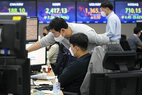 Currency traders watch monitors at the foreign exchange dealing room of the KEB Hana Bank headquarters in Seoul, South Korea (Photo | AP)