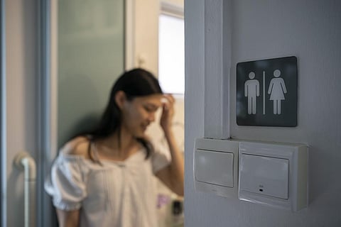 Lune Loh, 25, a transgender woman, leans against the door frame of her bathroom at home in Singapore, on Thursday, Aug. 18, 2022. (Photo | AP)