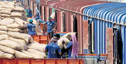 Workers loading the paddy procured in the district into railway wagons at Thanjavur station on Thursday | express