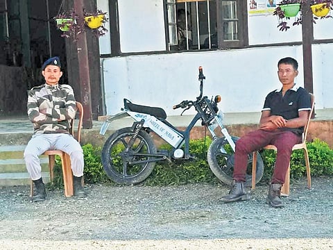 Noklak residents P Khuming (left) and Tumong with the e-bike made by them. (File Photo)