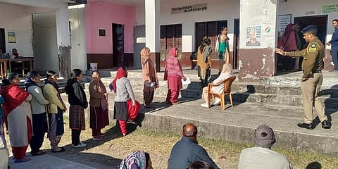 Voters wait in a queue to cast their votes for the Himachal Pradesh Assembly elections, at a polling station in Dharamshala district. (Photo | PTI)