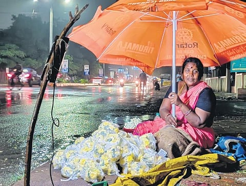 A flower vendor caught in the rain on Saturday | shiba prasad sahu
